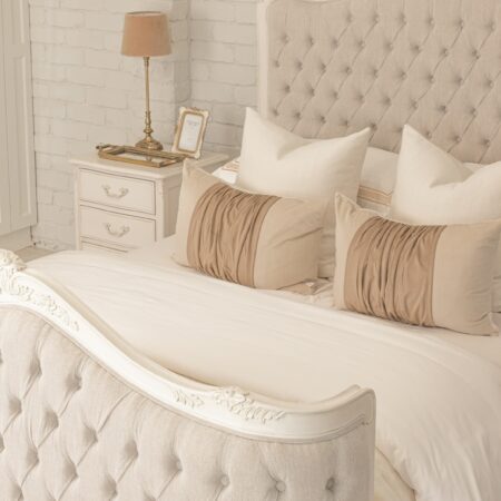 Alice French Provincial Bed in antique white with carved timber detailing and a button-tufted headboard and footboard